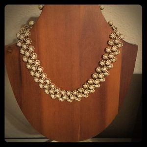Gold floral necklace.